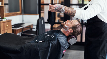 Beard, client and man in barbershop with hair care, shave and tools for trendy hairstyle at small...