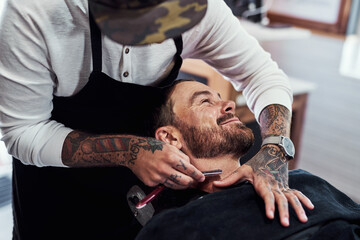 Beard, salon and barber with man for shave, haircut and grooming for hygiene, wellness and...