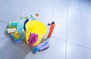 Assorted cleaning supplies and detergents on the bathroom floor
