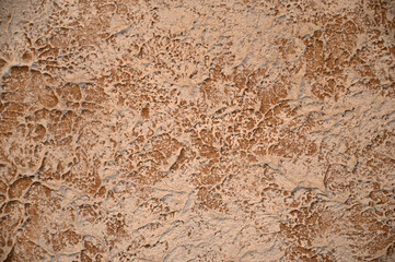 Textured background of brown and beige plaster