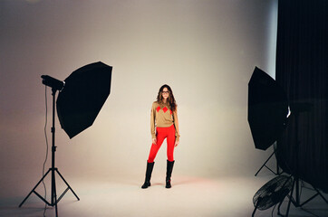 Young fashion woman posing in photo-studio film photo