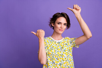 Photo of lovely cute girl wear trendy clothes two arms above head presents billboard empty space...