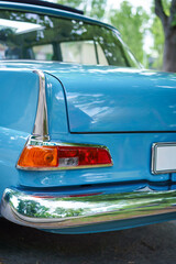 Close up of the tail light of a blue vintage car. Classic vehicle. Oldtimer car.
