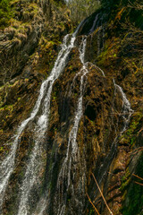 Spring creek under Simplonpass with waterfall in sunny day