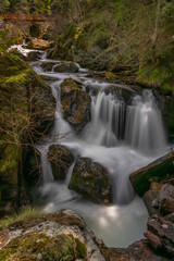 Fototapeta na wymiar Spring creek under Simplonpass with waterfall in sunny day