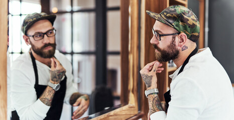 Man, mirror and looking for beard, barbershop and haircare for luxury salon startup. Barber, hairdresser and reflection for small business, store and. service industry entrepreneur with satisfaction