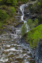 Waterfall in spring evening in valley of river Diveria in Gondo village