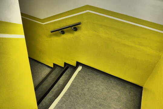 Bright Yellow Stairwell With Black Steps
