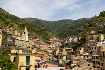 Fototapeta premium view of riomaggiore in italy with mountains in the background