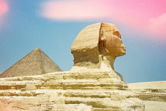 Profile of Sphinx with pyramid in the background