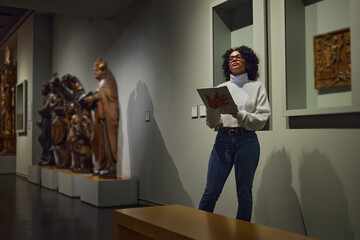 women in the museum looks at art exhibitions.