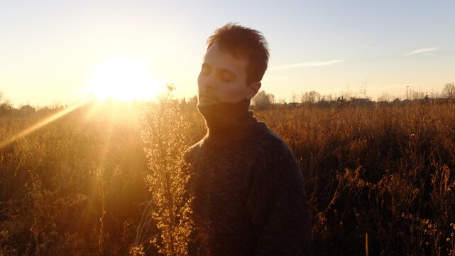 Serene Sunset Moment Captured as Man Meditates in Countryside