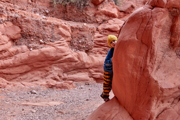 latin boy playing hide and seek on a mountain hike during winter vacation in Jujuy, Argentina