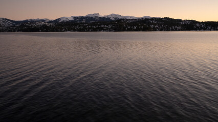 Fototapeta premium Panorama view of the Andes mountains and Alumine lake, at sunset, in Villa Pehuenia, Patagonia Argentina.