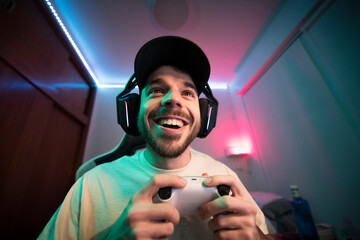 Young gamer enjoying video gaming at bedroom