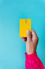 Close up seen from above of young woman hand with contact less credit card and chip on turquoise background