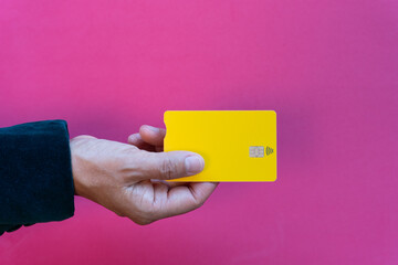 Concept purchasing with contact less debit card, close up of woman holding yellow debit card on...