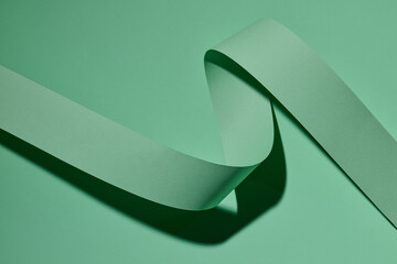 spiral paper on green background. ribbon lines