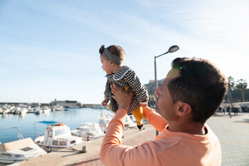 Father Lifting Daughter in Air
