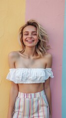 Naklejka premium A woman is smiling and wearing a white top and striped pants