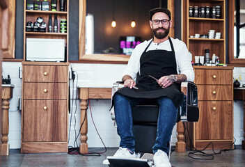 Barber, chair and portrait of man with tools for hair grooming, wellness and beard service....