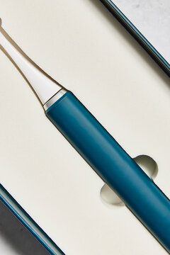 Blue electric toothbrush in a box