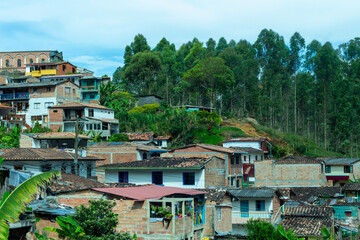Popular district in Jerico, jericó, Antioquia, Colombia. Poor houses, green trees, blue sky.