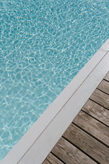 Beautiful view of swimming pool side with clear blue water with sunlight reflections on wave....