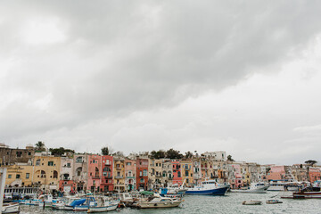 View from the shore. Coast of Procida Island, Italy. Old historic Italian architecture. Traditional European old town buildings. Vacation travel background
