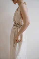 Beautiful woman in gorgeous creamy beige evening dress. Elegant beauty, fashion concept
