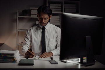 Businessman uses desktop computer, analysing, working with documents, solving problems, completing...