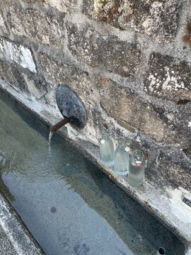 UGC glass bottles being filled with fresh water 