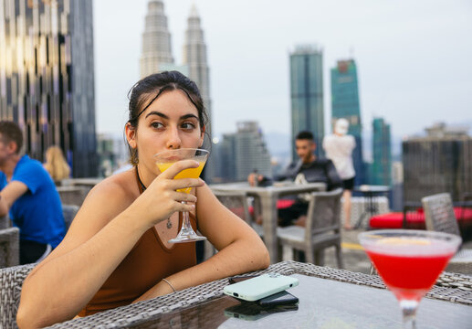 Young woman at a rooftop bar in the city of Kuala Lumpur