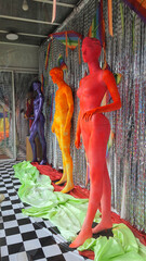 Different colourful mannequins in a store window to show gender diversity.