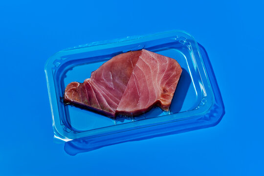 slices of raw tuna packed in a plastic tray