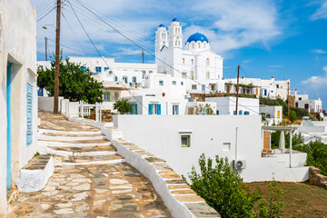 Narrow street path to white church with blue dome in Artemonas village, Sifnos island, Greece