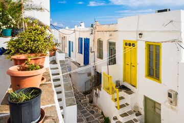 Narrow street with typical Greek houses decorated with flowers in Kastro village, Sifnos island,...