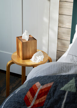 Tissue box next to a bed in a little boy's room