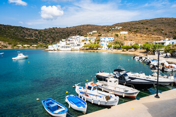 Typical Greek fishing boats anchoring in Faros port and mountains in background, Sifnos island,...