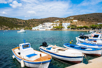 Typical Greek fishing boats anchoring in Faros port and mountains in background, Sifnos island,...
