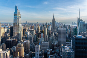 Vibrant cityscape with tall skyscrapers under clear blue sky from Top of the rock new york