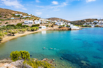 Green plants and view of azure sea on coast of Marina Gialos bay, Sifnos island, Greece