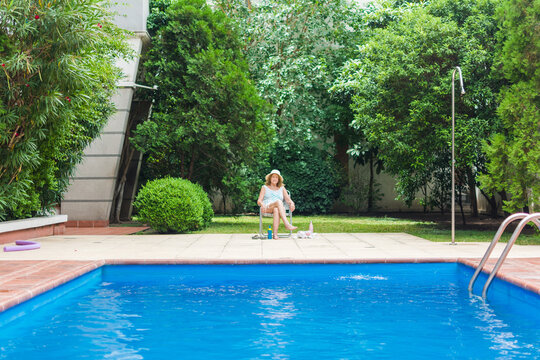 Senior woman relaxing by the pool