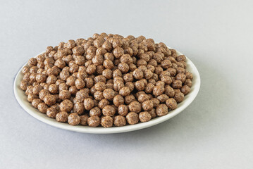 Dry breakfast balls on a plate on a gray background