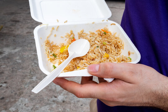 Anonymous person eating take away lunch. on the street.