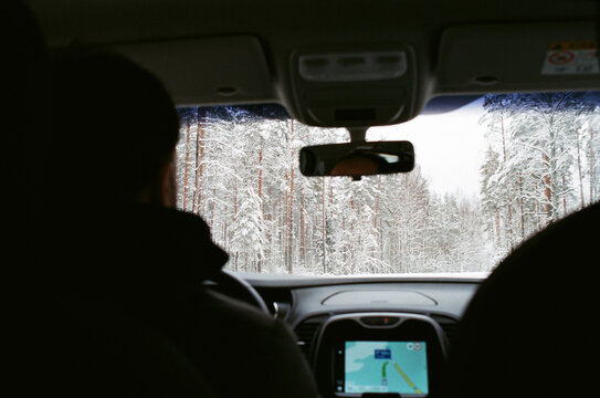Man drives car through snow forest
