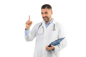 A man doctor dressed in a white lab coat stands confidently with one hand holding a clipboard and...