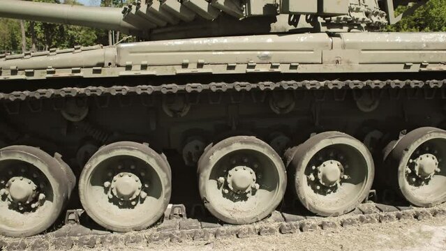 tracks and wheels of tank t80, armored vehicles on the street in green khaki color 