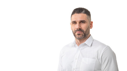 A man with a short beard and trimmed hair is standing against a plain white background, wearing a white button-up shirt. He has a neutral expression, panorama with copy space