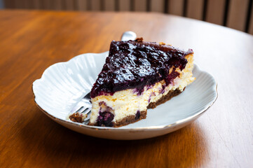 Slice of cheescake with blueberries on a table, Belgium